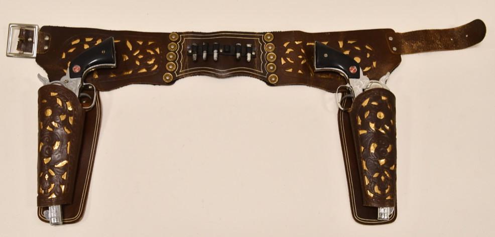 Nichols Stallion 45 Mark ll Cap Gun Set w/ Holster: Nichols Stallion 45 Mark ll cap gun set with leather holster. The cap guns are in nice condition with revolving cylinders with black grips. Both of the triggers work. The leather holster displays well