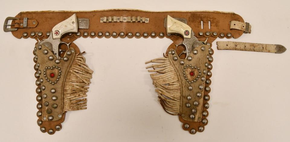 Hubley Texan Jr. Cap Gun Set with Holster: Nice Hubley Texan Jr. cap gun set with jeweled leather holster. The guns display well with the longhorn grips. The one trigger sticks. Overall displays well with wear from age and play.