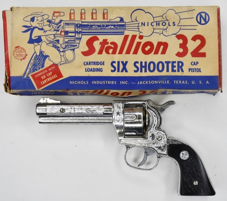 Nichols Stallion 32 Six Shooter Cap Pistol: Nichols Stallion 32 six shooter cap pistol with six cartridges and the original box. The cap gun displays very nicely with little to no wear. Measures approximately 7 3/4" long.