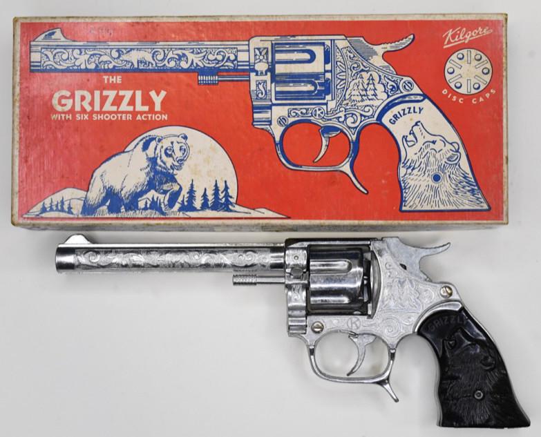Kilgore The Grizzly Six Shooter Cap Gun: Kilgore The Grizzly cap gun pistol with six shooter action. Displays very nicely with the original box. The gun is in very nice conditionand displays well with the Grizzly bear grips. Measures approxi
