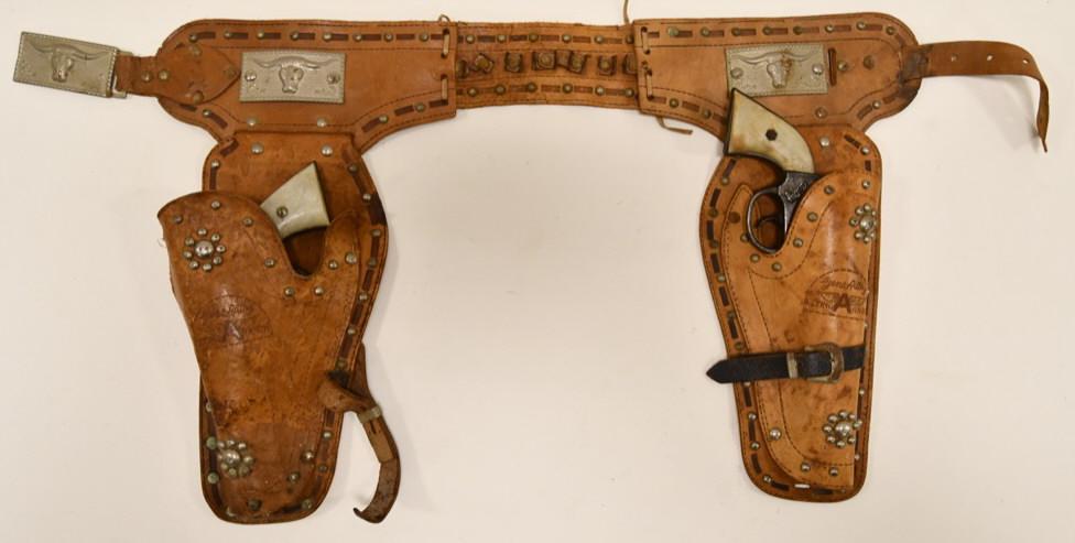 Kenton Gene Autry Cap Gun Set with Holster: Nice set of Kenton Gene Autry cap guns with leather holster. The cap guns display well with some wear from age and use. Both triggers work, but the one sticks. The leather holster has wear from age. P