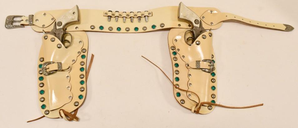 Russel Cowboy Holster Cap Gun Set: Russl Cowboy Holster cap gun set in the box. Set include (2) Texas cap guns that are marked Long Island Die Casting Inc and a nice double leather holster. Displays nicely with very light wear from sto