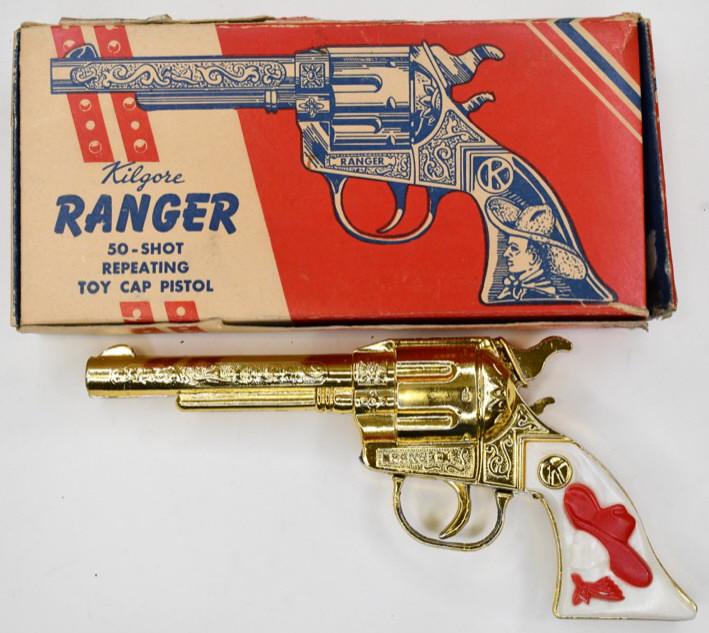 Gold Kilgore Ranger Cap Gun Pistol: Gold Kilgore Ranger cap gun pistol with the box. The pistol displays nicely with a golden color with cowboy grips. The trigger works. Gun measures approximately 8 3/4" long.