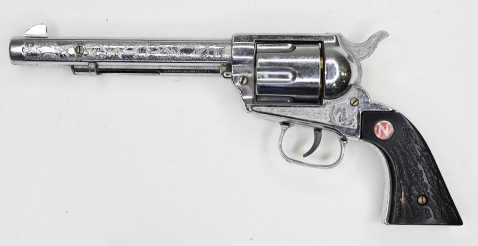 Nichols Stallion 45 Mark ll Cap Gun Pistol: Nichols Stallion 45 Mark ll cap gu pistol with revolving cylinder. The pistol comes with 6 bullets. The trigger, cylinder, and hammer work. Displays nicely with wear from use and age. Measures approxi