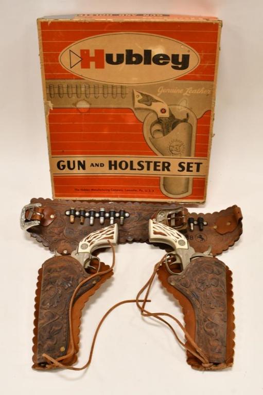 Hubley Colt .38 Cap Gun and Holster Set: Hubley Colt .38 cap guns and holster set with box. The box has tap, staining, and wear from age. The pair of Colt .38 cap guns display well with matching Colt .38 double leather holster. The guns have