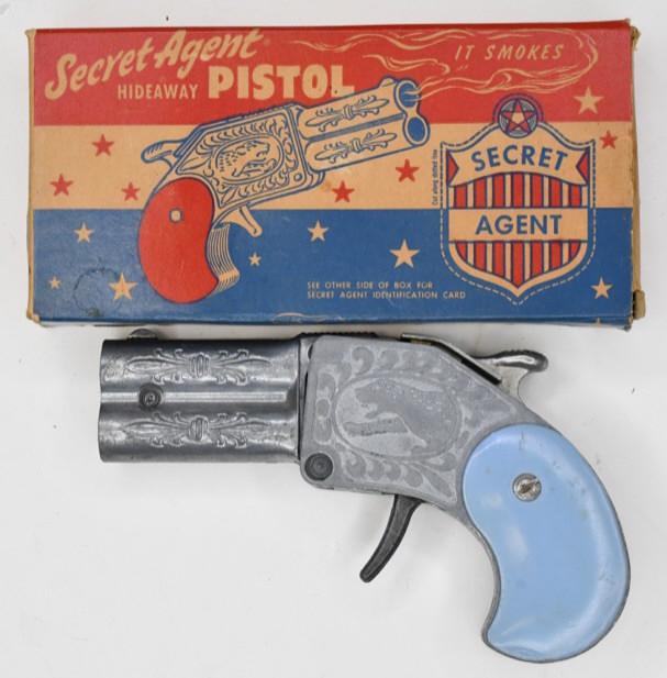 Hamilton Specialties Secret Agent Hideaway Cap Gun: Hamilton Specialties Secret Agent Hideway pistol with the original box. Displays nicely with light wear from play and age. The trigger works. The box displays nicely with good color. Gun measures appr