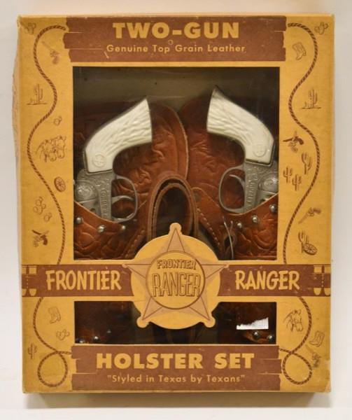 Frontier Ranger Cap Gun Set with Leather Holster: Frontier Ranger cap gun pistol set with leather holster. Set includes (2) Hubley Rodeo cap gun pistols, and a double leather cap gun holster. The one cap gun trigger does not work. Overall the set dis