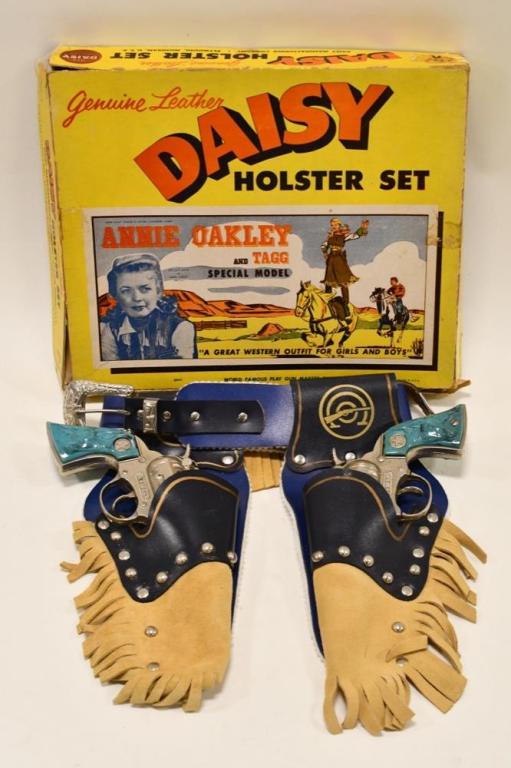 Genuine Leather Daisy Holster Set w/ Cap Guns: Genuine leather Daisy holster set with cap guns. Set includes (2) Western cap guns made by Hubley and a double leather holster. The cap guns display nicely with the blue longhorn grips. Both triggers 