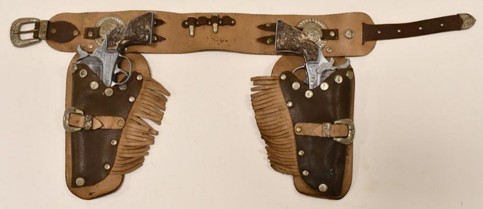 Kilgore Roy Rogers Cap Gun Set w/ Holster: Kilgore Roy Rogers cap gun set with Roy Rogers leather holster. The cap guns are in nice condition with some wear from age. Both triggers work. The holster has wear to the leather from play and age. C