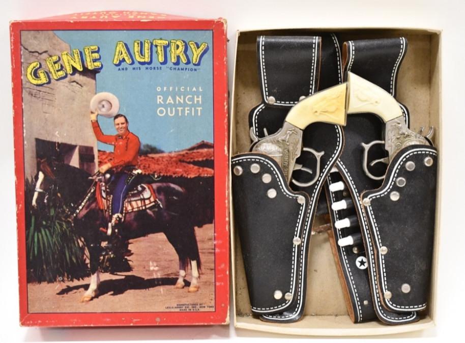 Leslie-Henry Gene Autry Official Ranch Outfit: Leslie-Henry Gene Autry official ranch outfit set with the box. The set includes (2) Leslie-Henry Gene Autry cap guns and a leather holster. The triggers work, but the one gun doesn't stay latched. Th