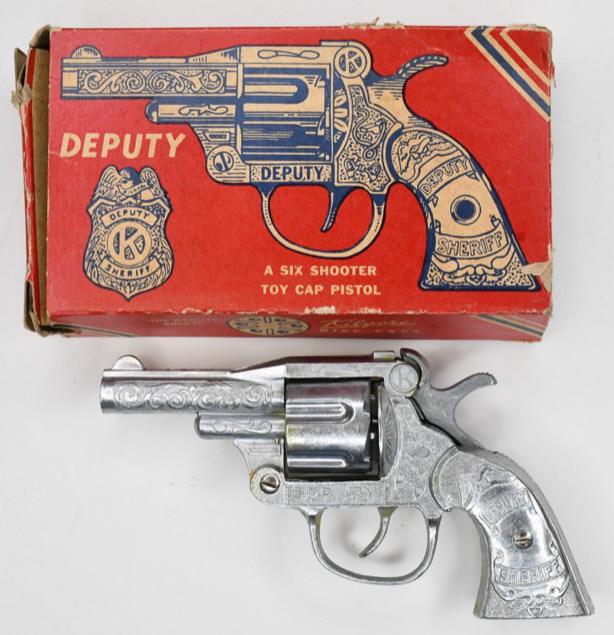 Kilgore Deputy Six Shooter Cap Gun Pistol: Kilgore Deputy six shooter cap gun pistol with revolving cylinder with the original box. The box is missing some end flaps. The cap gun has some wear from age and play. The trigger works. Displays nic