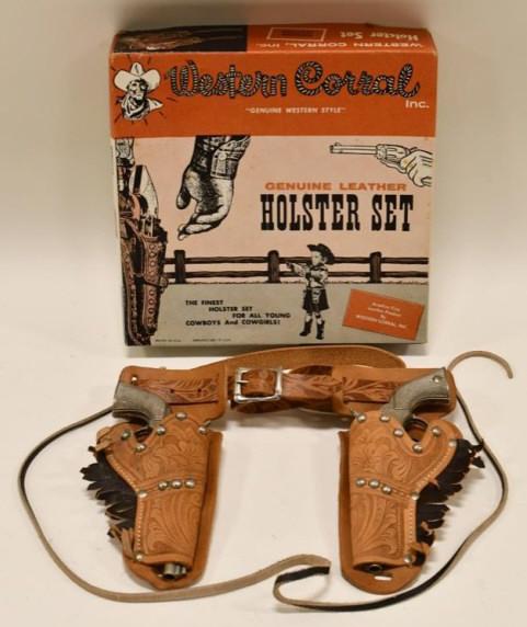 Western Corral Inc. Holster Set with Cap Guns: Western Corral Inc. holster set with Hubley Pet cap guns with the box. Cap guns are in nice condition with light wear from age. The holster has light waer to the leather. The box displays very nicely