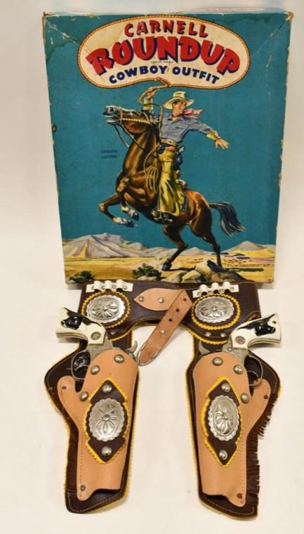 Carnell Roundup Outfit Cap Gun Set w/ Holster: Carnell Mfg. Roundup cowboy outfit with the box. The outfit includes a Carnell Roundup leather holster and (2) Hubley Texan Jr. cap guns. The cap guns display nicely with longhorn grips. Both triggers
