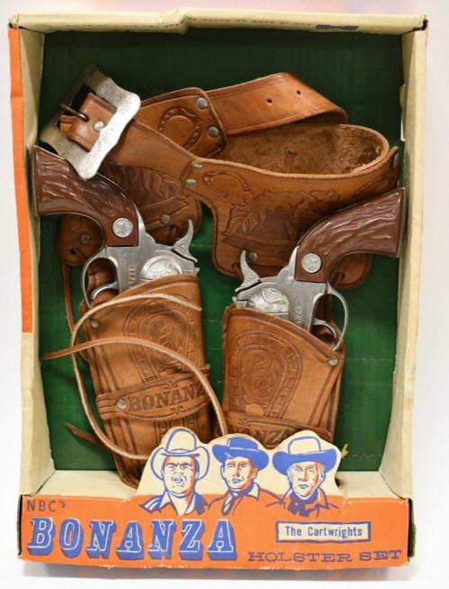 Halco Bonanza Holster and Cap Gun Set: Halco Bonanza holster and cap gun set with the original box. The Halco Bonanza cap guns are in very nice condition with light wear from age. The Bonanza holster has light wear to the leather. Overall