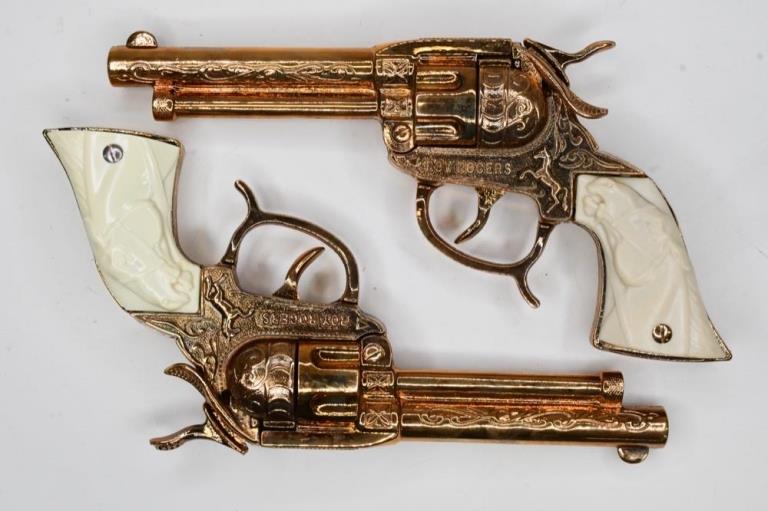 Gold Leslie-Henry Roy Rogers Cap Gun Set: Gold Leslie-Henry Roy Rogers cap gun set. The set is in exceptionally nice condition for its age. Hardly any wear to the grips or hammer. Displays very nicely. Cap guns measures approximately 8" long.