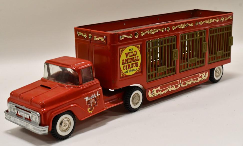 Buddy L Wild Animal Circus Truck: Original Buddy L Wild Animal Circus truck. Includes a lion, elephant, and tiger. The plastic clear roof on the trailer has a chunk missing. Displays nicely with wear from age and display. Overall meas