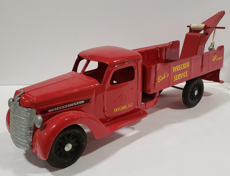 Custom Buddy L Wrecker Truck: Custom Buddy L International Bob's wrecker service. Displays nicely with good restoration. Has light wear from storage and display. Measures approximately 24" long.