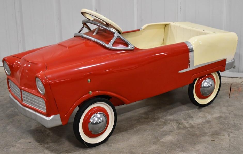 Custom Murray Lancer Pedal Car: Custom restored Murray Lancer chain driven pedal car. Displays nicely with opening trunk. Nice condition with some light wear from storage and display. Measures approximately 38" long.