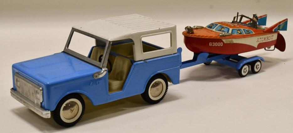 Buddy L Colt Pickup Truck w/ Boat & Trailer: Buddy L Colt pickup truck with tin litho boat and trailer. The Japan tin litho Harbor Command has paint loss and wear, but is in working condition. DIsplays nicely with wear from play and age. Overall
