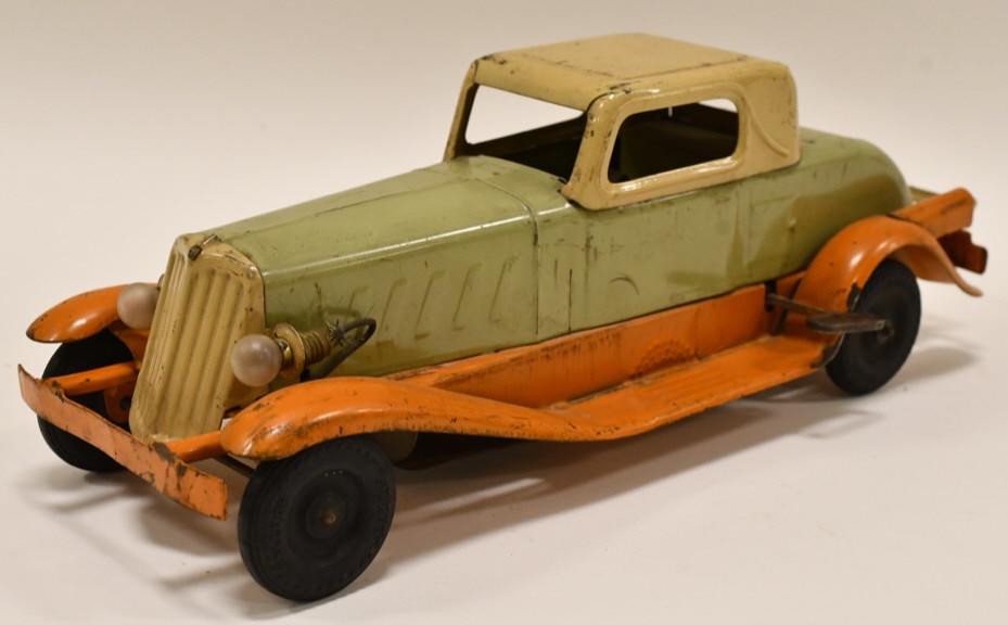 Girard Windup Pierce Arrow Coupe Roadster: Girard windup Pierce Arrow Coupe Roadster. Displays nicely with luggage rack and headlights. Nice condition with some paint loss and wear from play and age. Measures approximately 14 1/2" long.