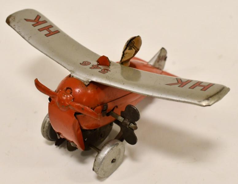 U.S. Zone Germany Tin Windup Rollover Plane: U.S. Zone Germany tin litho windup rollover plane.Displays nicely with the original pilot. Nice condition with light war from play and age. The windup mechanism works. Measures approximately 5" long.