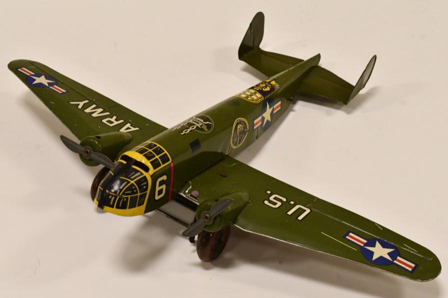 Marx Windup Tin Litho U.S. Army Fighter Plane #6: Nice original Tin Litho Marx Windup U.S. Army Fighter Plane #6. The plane has very little wear and works well. Measures approximately 13 1/2" long with a 18 1/4" wingspan.