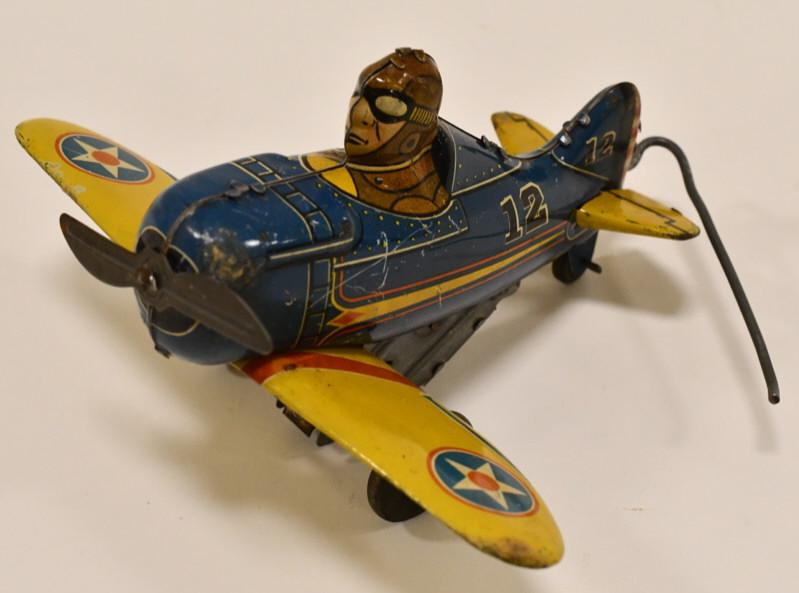 Marx Tin Windup Rollover Plane No. 12: Marx tin litho windup rollover plane no. 12. Nice condition with light wear from age and play. Windup mechanism works. Measures approximately 5 1/2" long.