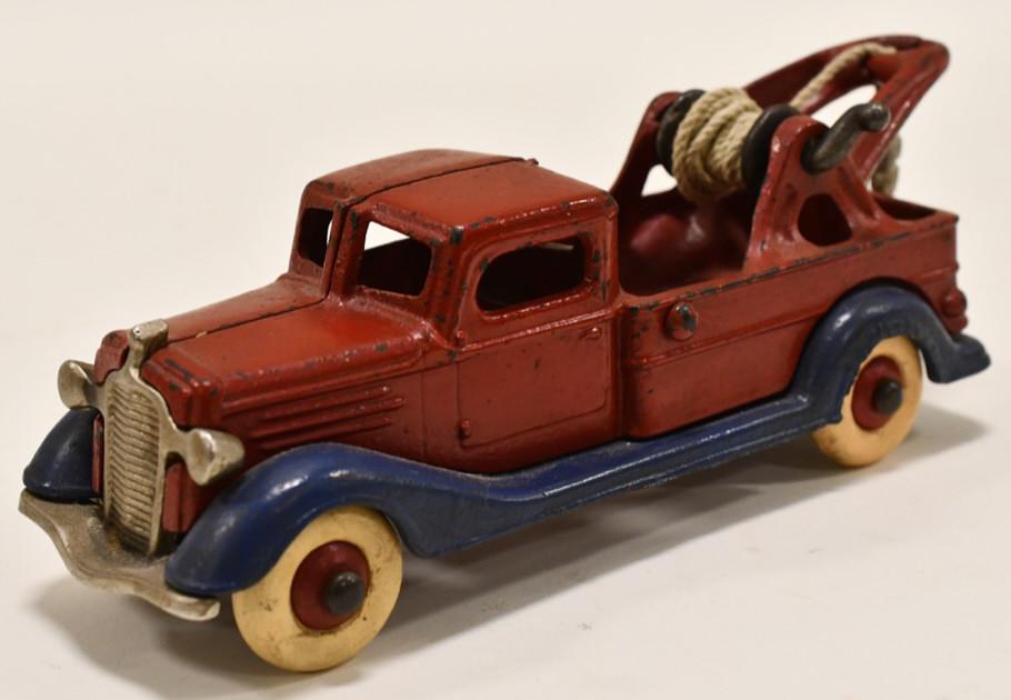 A.C. Williams Cast Iron Wrecker Tow Truck: Cast iron wrecker tow truck. The truck is unmarked. Possibly made by A.C. Williams. Displays nicely with wear from play and age. Still has the original winch and tow hook. Measures approximately 7 1/2