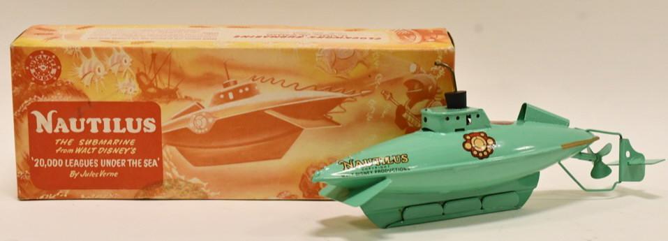 Sutcliffe Windup Walt Disney Nautilus Submarine: Sutcliffe tin litho windup Walt Disney Productions Nautilus submarine in the box. It is missing the key. The box has some water damage. Displays very well with light wear from play and age. Measures a