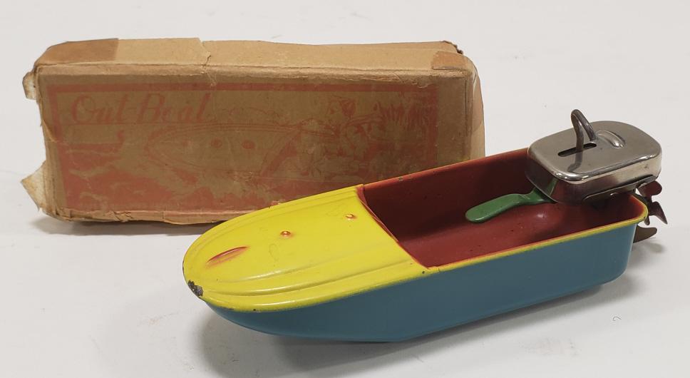 Japan Tin Windup Out-Boat w/ Outboard Motor: Japan tin windup out-boat with outboard motor and original box. The outboard motor has the windup and works with some help. The box has wear and tear from age. Measures approximately 6" long.