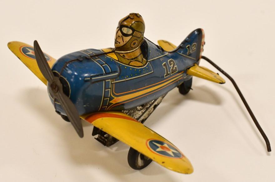 Marx Tin Windup Rollover Plane No. 12: Marx tin litho windup rollover plane no. 12. Nice condition with light wear from age and play. Windup mechanism does not work. Measures approximately 5 1/2" long.