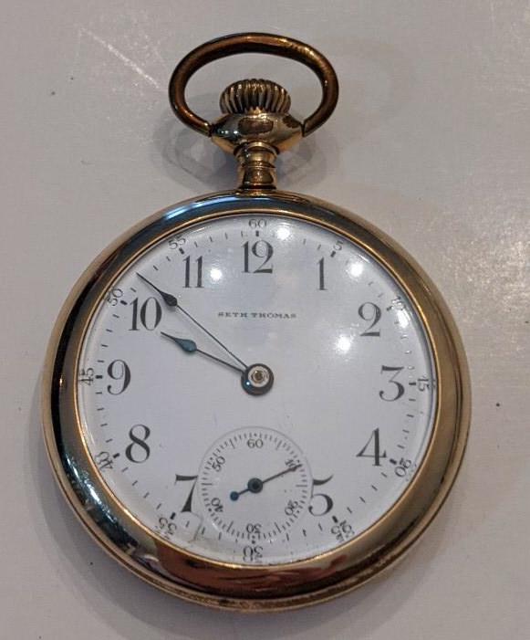 Seth Thomas New Eagle 7J Open Face Pocket Watch: Nice running Seth Thomas 7 Jewel Model 8 Grade 36 Open Face Pocket Watch. The 18 size pocket watch measures approx. 2-1/8" in diameter and has an Illinois 20 year case. The case has some wear. The fac