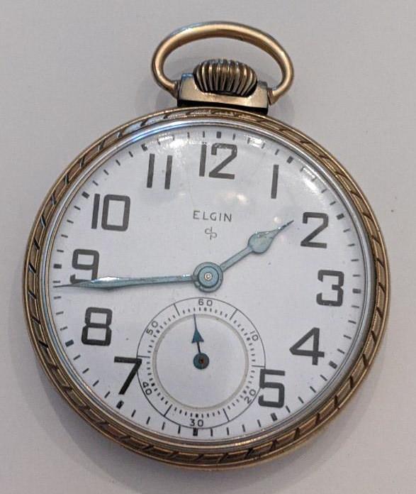 1951 Elgin 575 15 Jewel Open Face Pocket Watch: Nice running Elgin 11 Jewel Model 20 Grade 575 Open Face Pocket Watch. The 16 size pocket watch measures approx. 2" in diameter and has an Elgin 10k rolled gold plate case. The case shows some wear. T