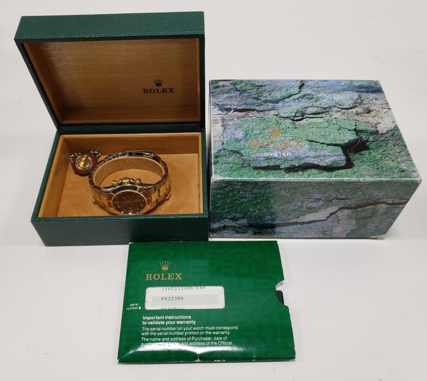 2000 Rolex Cosmograph Daytona Two-Tone Watch: Beautiful 2000 Rolex Cosmograph Daytona Two-Tone wrist watch. The stainless steel & 18k yellow gold watch is style # 116523330B7849. The watch is in great used condition with the original box,instruct