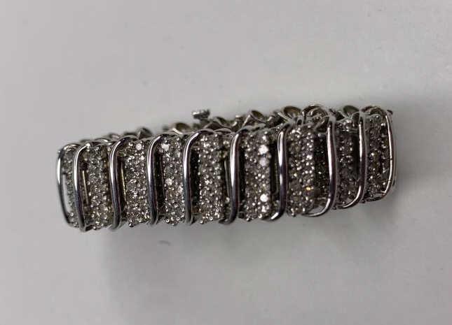 10k White Gold and Diamond Tennis Bracelet: 10k White Gold and Diamond Tennis Bracelet. 7" long. Weighs: 16.84 grams.