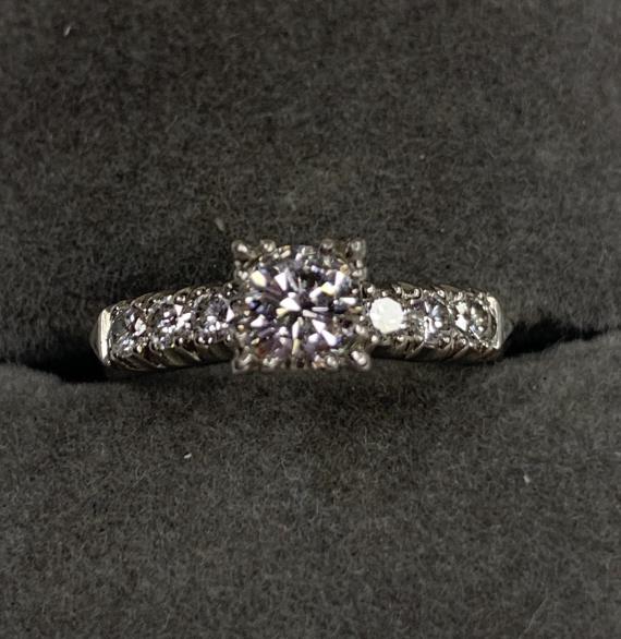Platinum .75 cttw Diamond Ring: This nice ring has an approximate 50 point center stone and 6 side stones totaling .75ct. Size: 8. Weighs: 4.7 grams