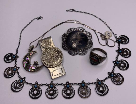 Lot of 5 Pieces of Sterling Silver Jewelry: 1) Mexican Alpaca money clip. Weighs: 23.41 grams. 2) Multi gemstone sterling silver ring. Weighs: 10.76 grams. Size: 12. 3) Signed Liam Sterling Asian themed pin. Weighs: 10.6 grams. 4) Sterling silv