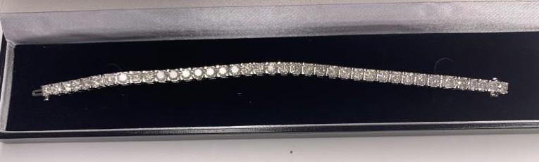 10k White Gold 15cttw Diamond Tennis Bracelet: 7.5" in length. Comes with a replacement value appraisal of $24,900.