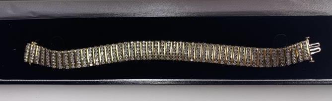 Diamond Tennis Bracelet: Gold Tone. 7" in length.