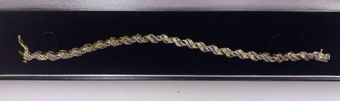 Diamond Tennis Bracelet: Gold tone finish. 7.5" long