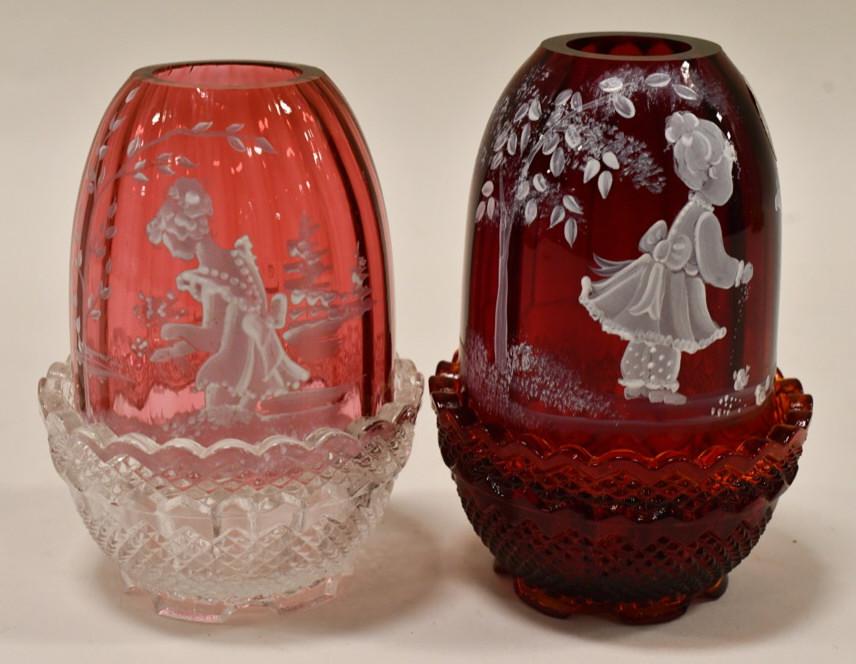 Pair Of Fenton Mary Gregory Fairy Lamps: Nice pair of Fenton Mary Gregory Fairy Lamps. Cranberry glass lamp measures 4.25" tall and the ruby red glass lamp measures 4.5" tall. Both are in nice condition.