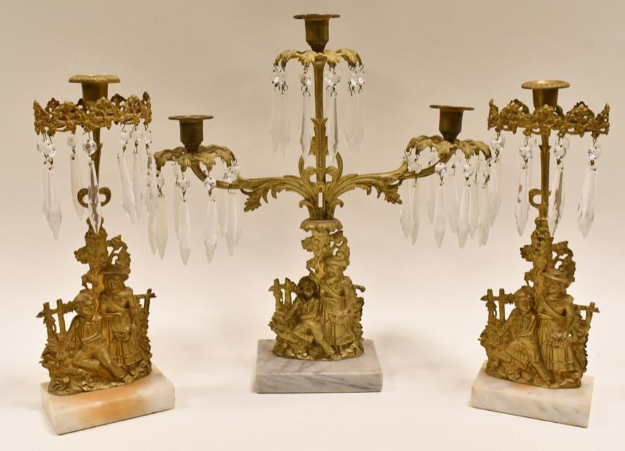 Three Piece Victorian Candelabra Set: Beautiful three piece Victorian candelabra set. The set is made of gold washed cast metal and brass on marble bases with prisms. The set includes two 14" single light candlesticks and one 17" three-li
