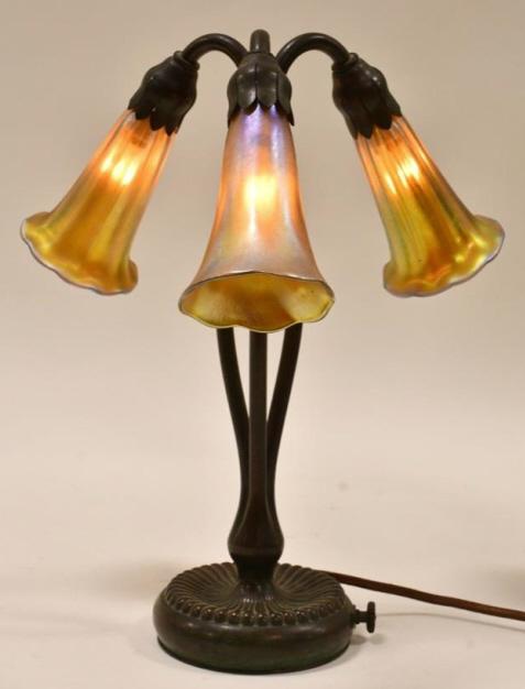 Tiffany Studios 3-Light "Lily" Table Lamp #319: Beautiful Tiffany Studio New York 3-light Gold Favrile "Lily" lamp #319. The bronze lamp has one shade marked LCT with an internal rim crack that is hidden when in place, the two other shades are vint