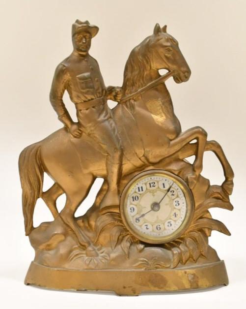 Ca. 1899 Theodore Roosevelt "Rough Riders" Clock: Ca. 1899 Western Clock Mfg. Co. Theodore Roosevent "Rough Riders" clock. The cast metal with gold finish clock measures approx. 10-1/2" tall x 8-3/8" across and features Theodore Roosevelt on his hors
