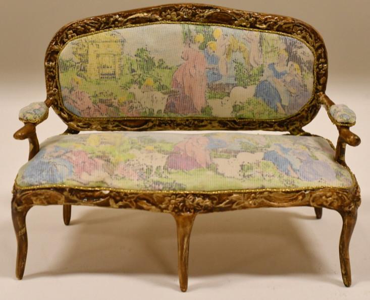 Dollhouse Miniature French Settee By Sara Heritage: Beautiful miniature French tapestry settee by artisan Sara Elisabeth Heritage. Nice condition with a crack on the rear left leg. The settee measures 3-1/4" tall x 4-3/4" across x 2" deep and is signed