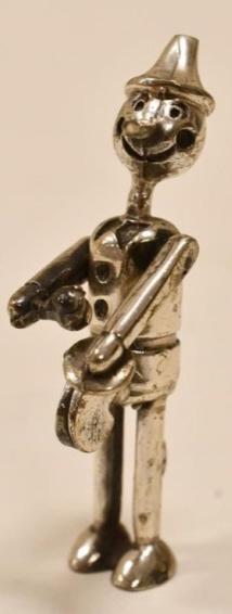 Dollhouse Miniature Artisan .800 Silver Pinocchio: Beautiful dollhouse miniature .800 silver Pinocchio with moving arms. The doll is in wonderful condition and measures 1-7/8" tall.