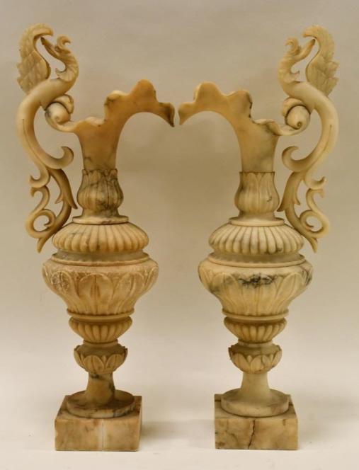 Pair Of Late 19th Century Carved Alabaster Ewers: Nice pair of late 19th century carved alabaster ewers. The ewers have an Art Nouveau carved leaf design. The condition is nice with a few small edge dings, one has a crack on the base. They measure 21