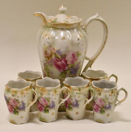 Seven Piece German Porcelain Chocolate Set: Beautiful vintage German porcelain chocolate set. The set includes the chocolate pot and six cups. The condition is very nice with no chips or cracks. The pot measures 9-1/2" tall and the cups measure