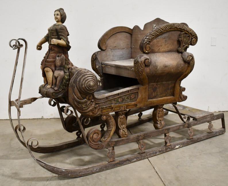 French Style Hand Carved Wood & Wrought Metal Sled: As found French style hand carved and painted sled with wrought metal runners. Nice detail with woman and dog statue in the front. Measures 49" tall x 81" across x 32" deep.