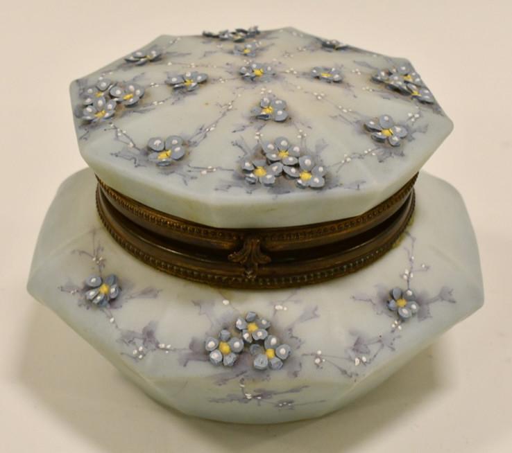Antique C.F. Monroe "Nakara" Dresser Box: Beautiful antique C.F. Monroe Company "Nakara" dresser box. The hinged box measures 4.75" tall x 7" in diameter. It is in nice condition with some chips on the applied flowers. Marked on the base.